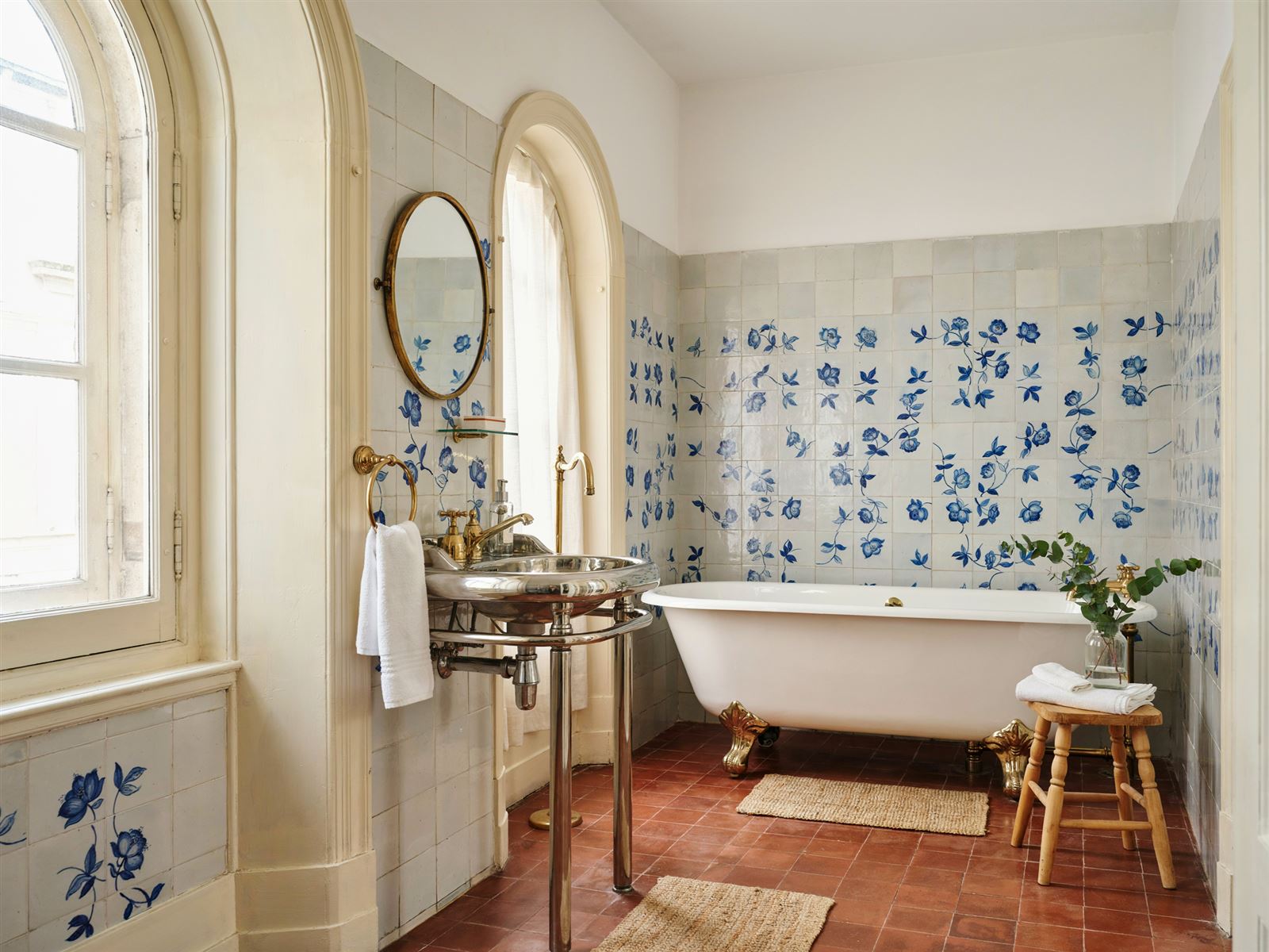 Casa de banho antiga limpa a fundo, com azulejo e metais a brilhar